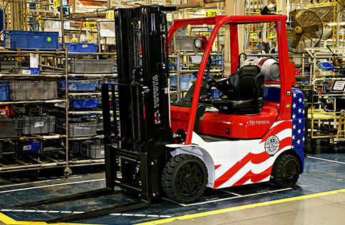 A Toyota forklift that is painted to resemble the USA Flag is parked in a warehouse 
