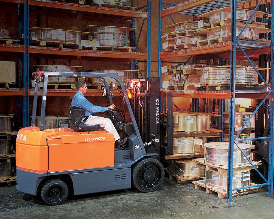 Man driving Toyota forklift in warehouse 